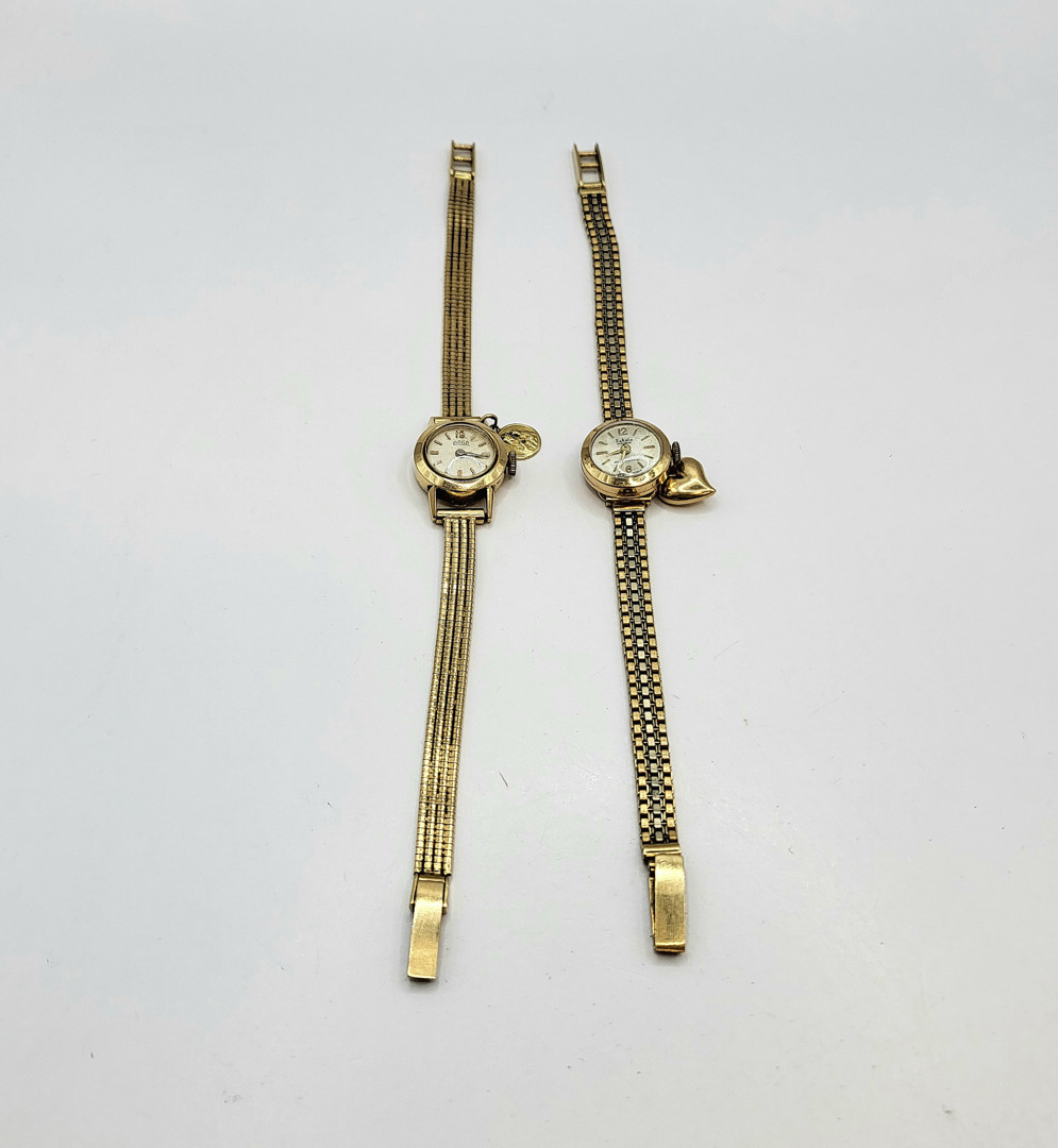 Due orologi e ciondoli oro