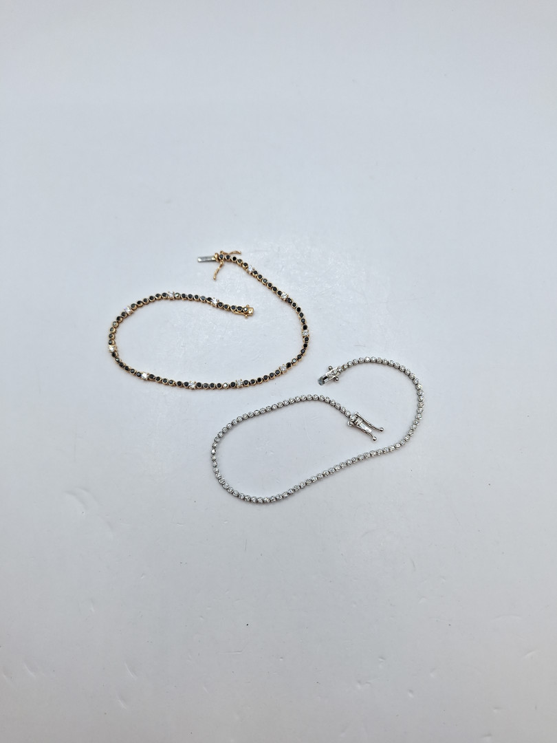 Due bracciali "tennis" oro pietre diamantini 
