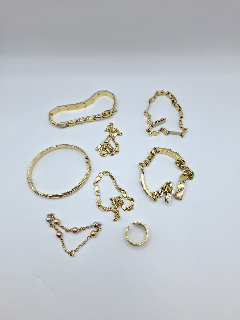 Sette bracciali e anello in oro pietra