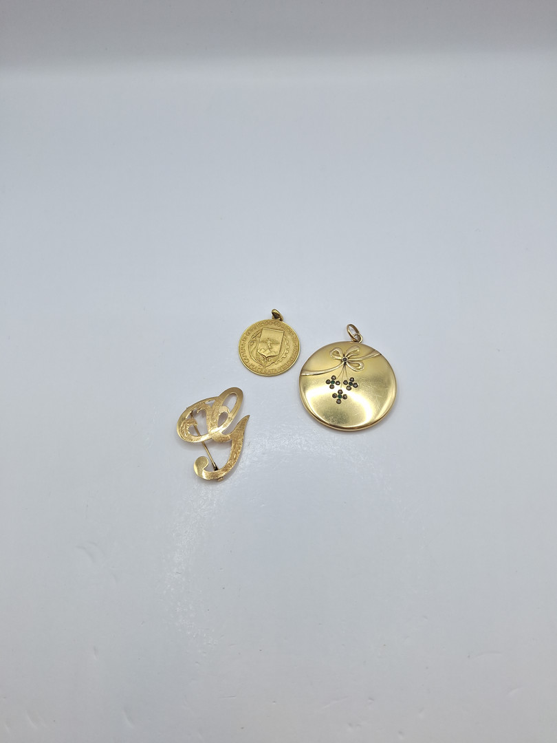 Un paio di ciondoli spilla oro pietre diamantini