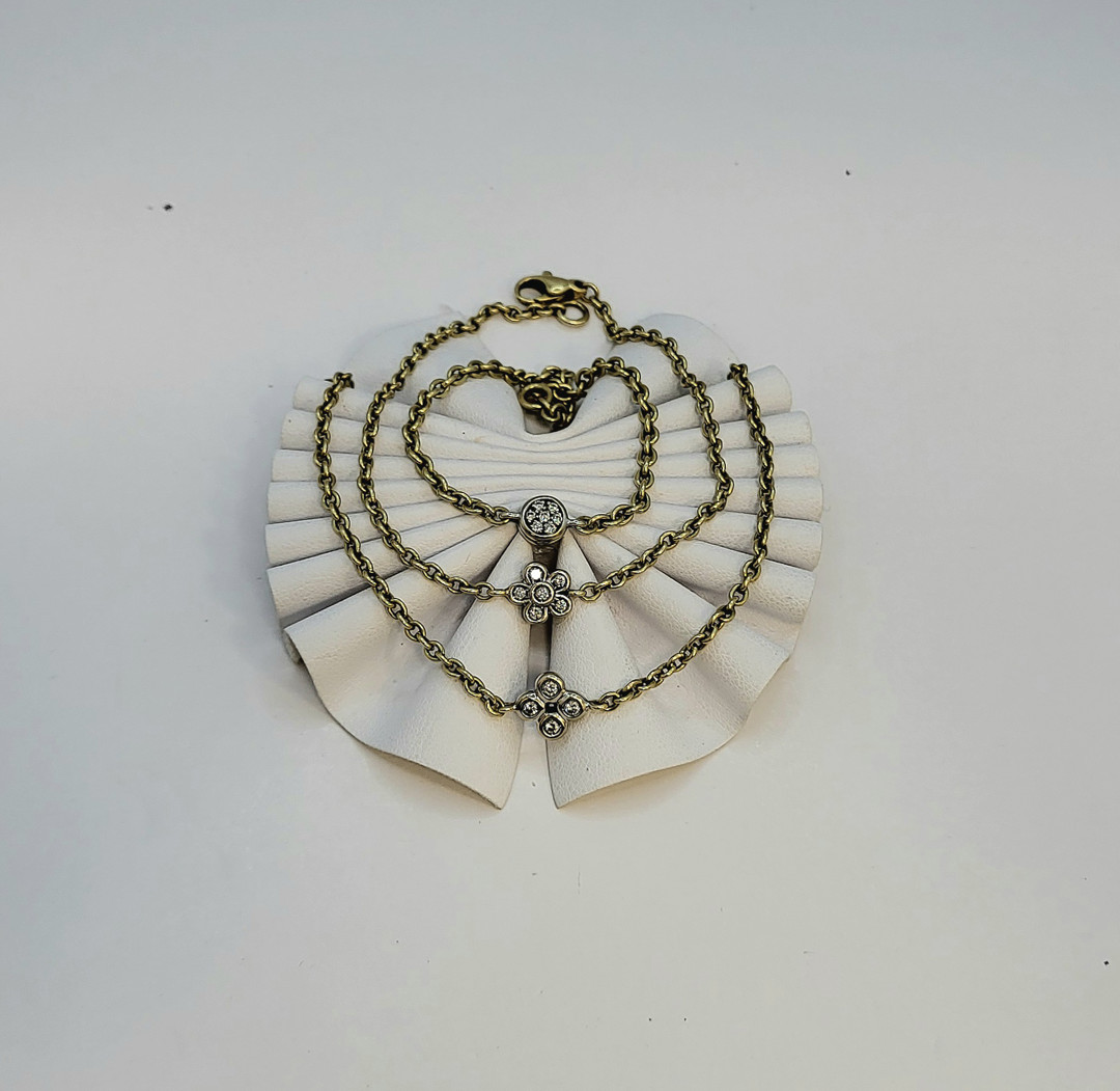 Tre bracciali oro diamantini